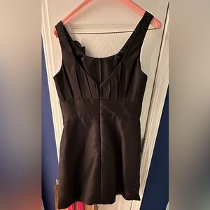 Little black dress, pockets, cute flower, hits just above the knee, size 10/12